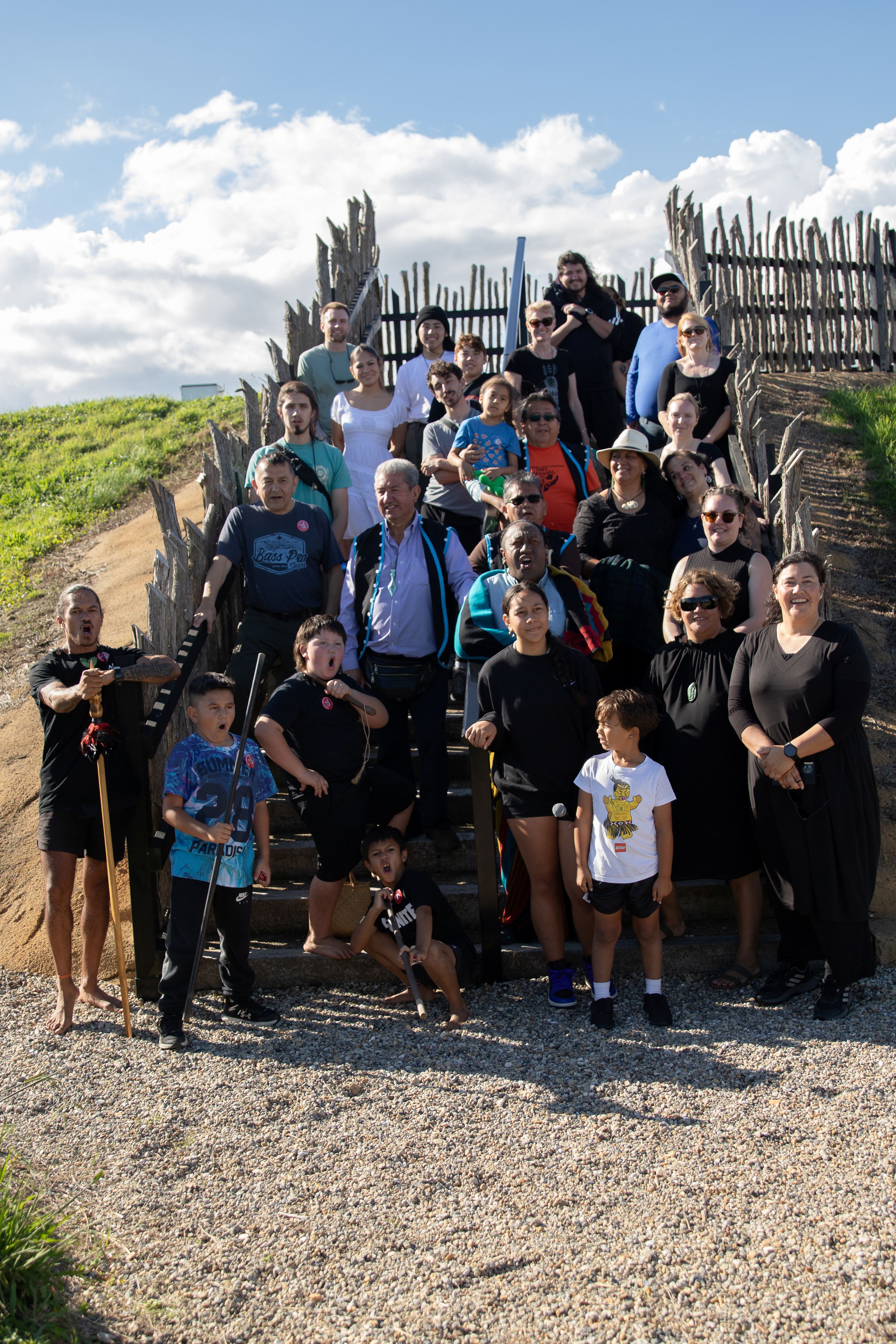 a group of people gathered on a boardwalk.