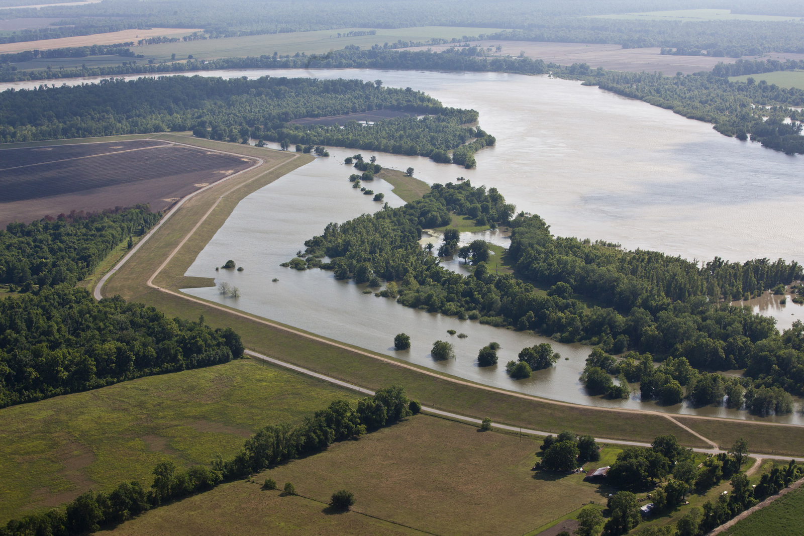 An aerial image depicts a river diverted through farmland..
