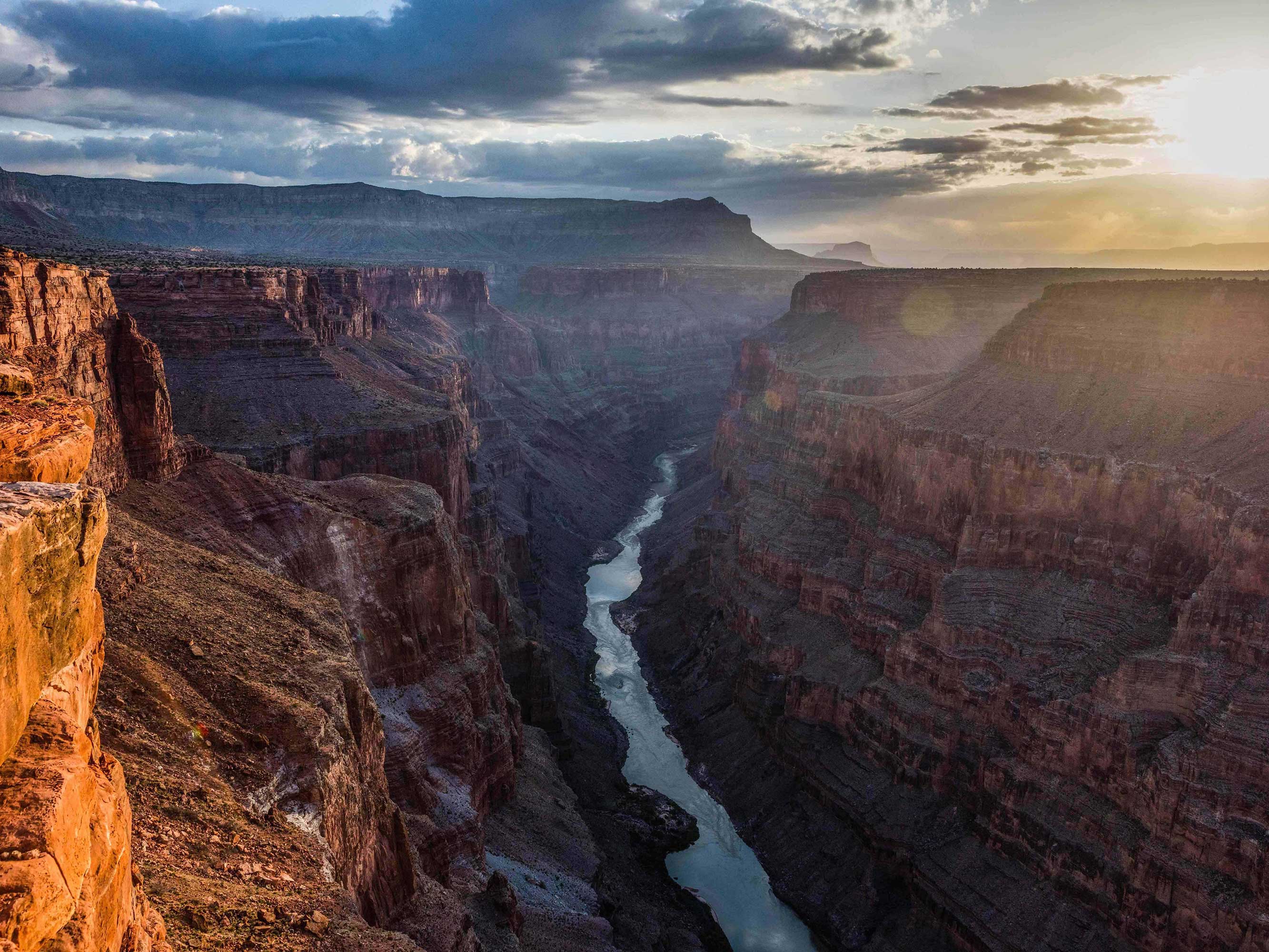 The Colorado River flows through the Grand Canyon.