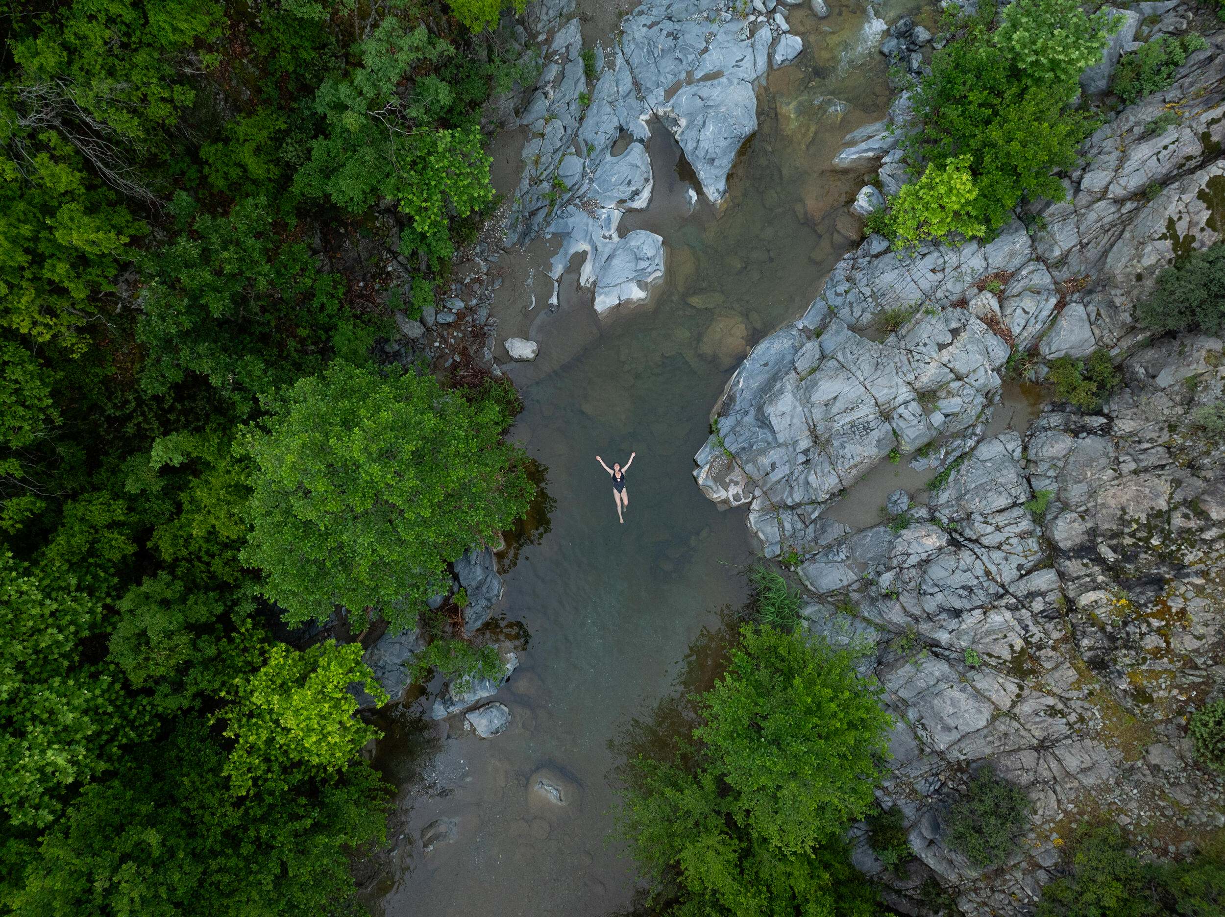 Woman swimming in hot spring of Vardar river.