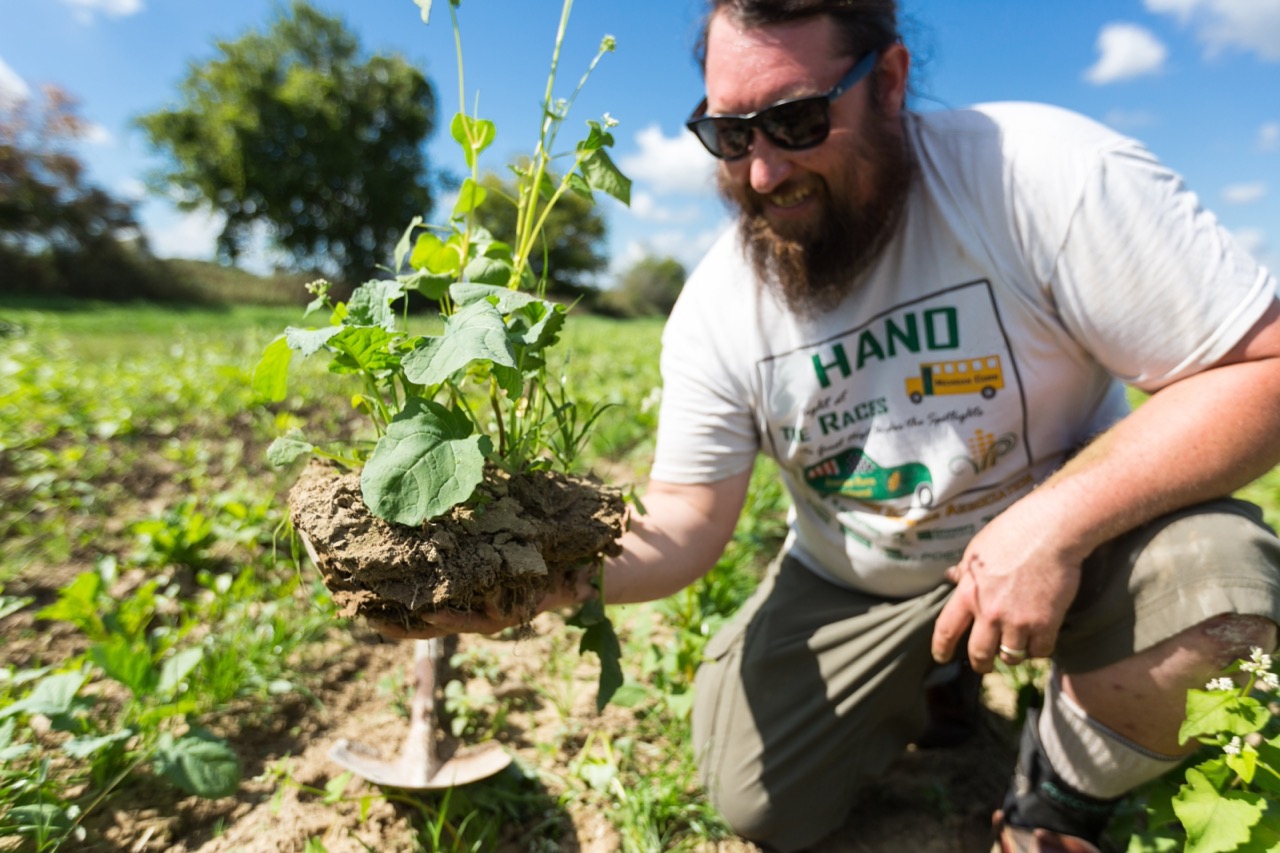 A farmer holding a crop.