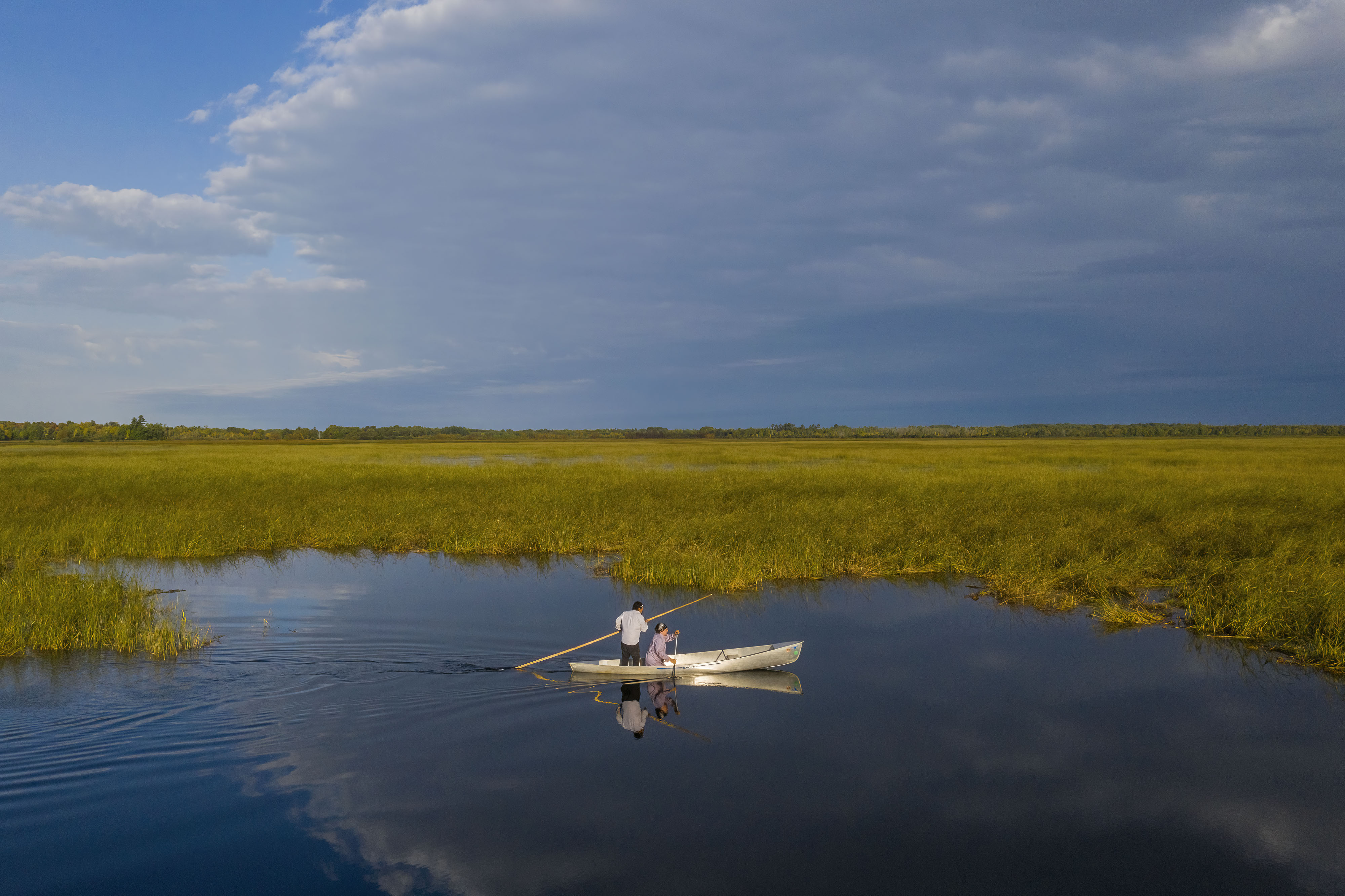 Shannon Wadena and his son, Shannon Jr. (right),  work their canoe across Upper Rice Lake near Bagley, Minnesota.