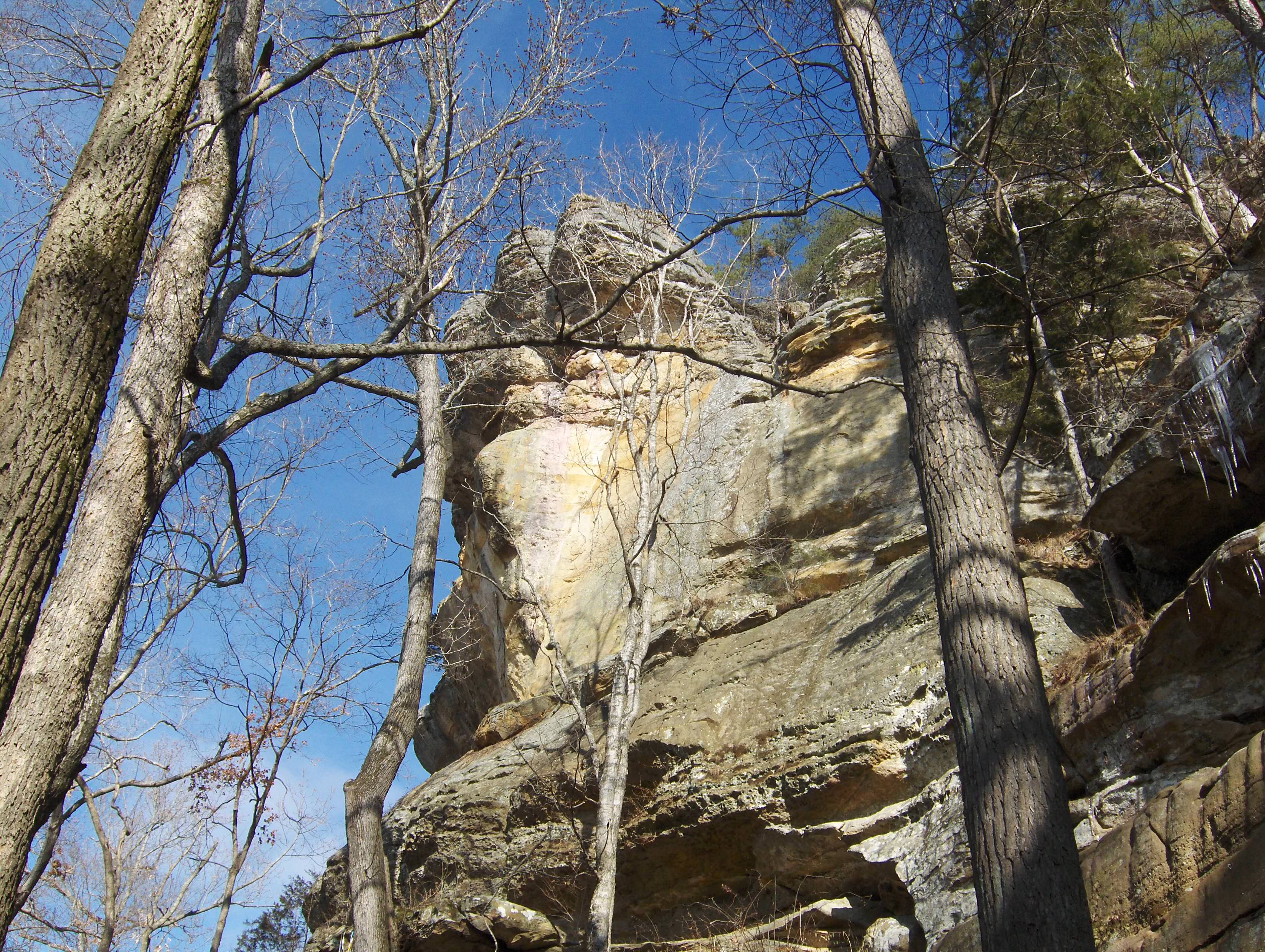 A rocky bluff juts out under a blue sky.