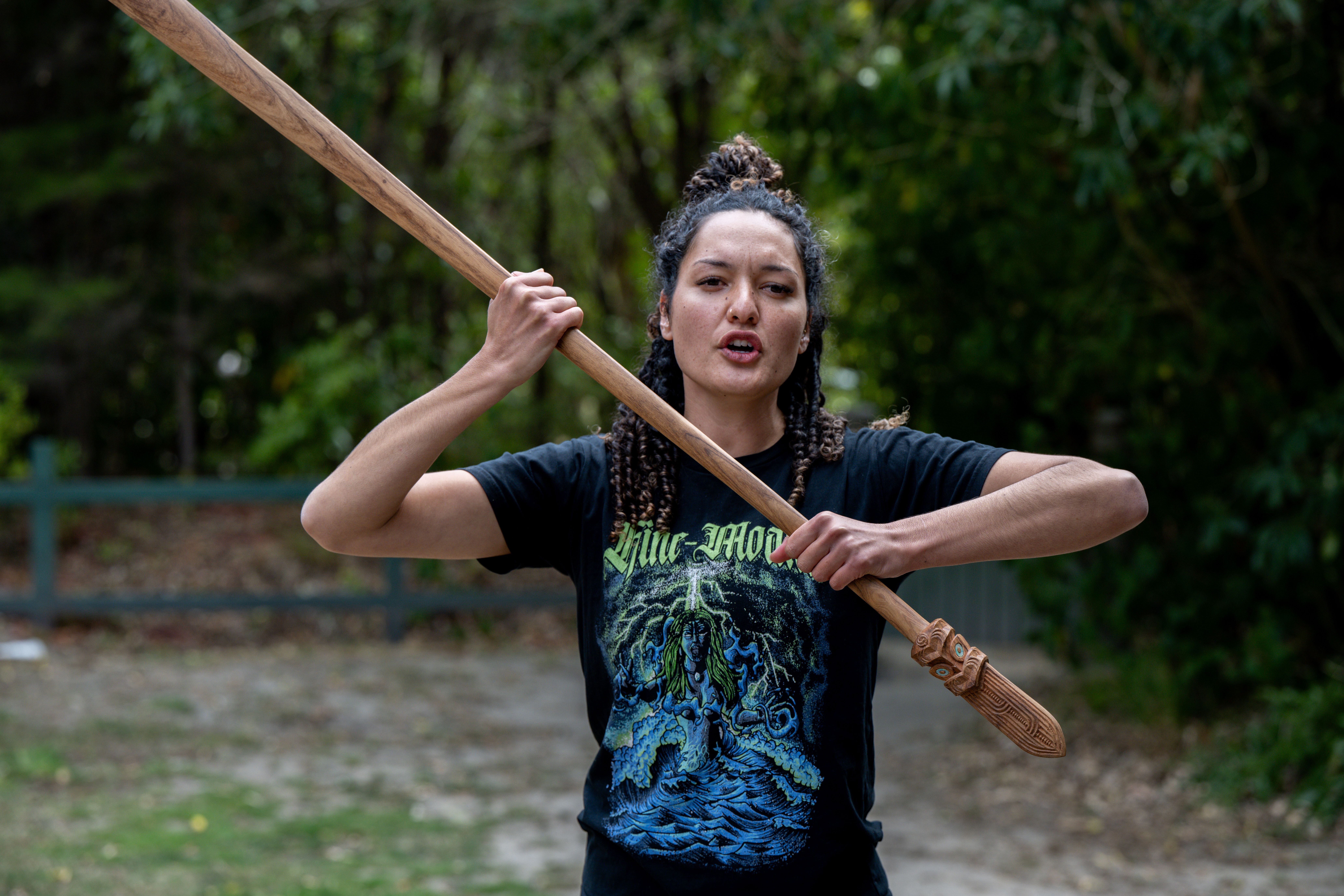 Kiara Duke-Love, from Te Atiawa, taking some of the roopu (group) through a mau rākau (Māori weaponry) sequence.
