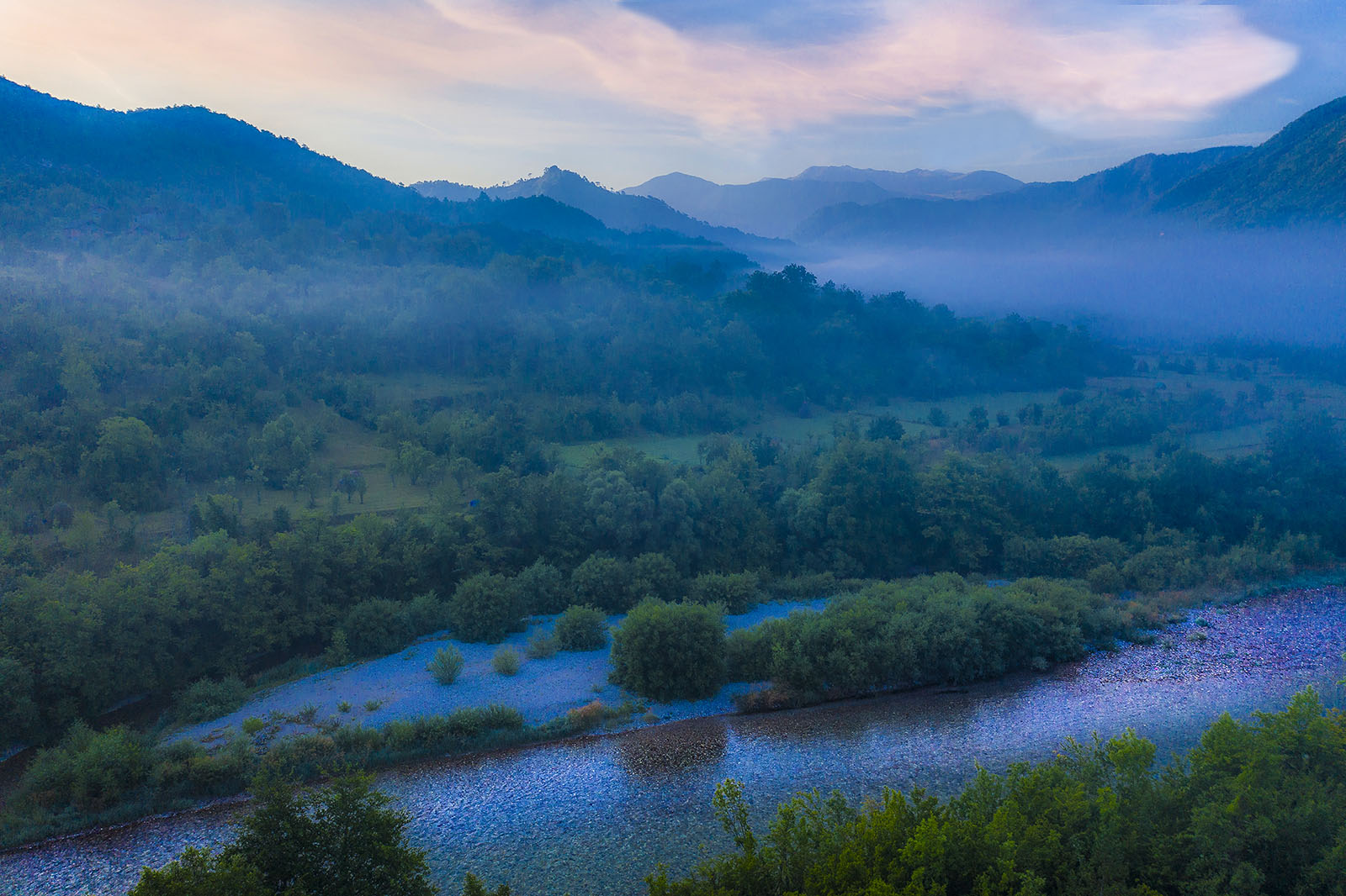 Nerevta River in front of a foggy rural backdrop.