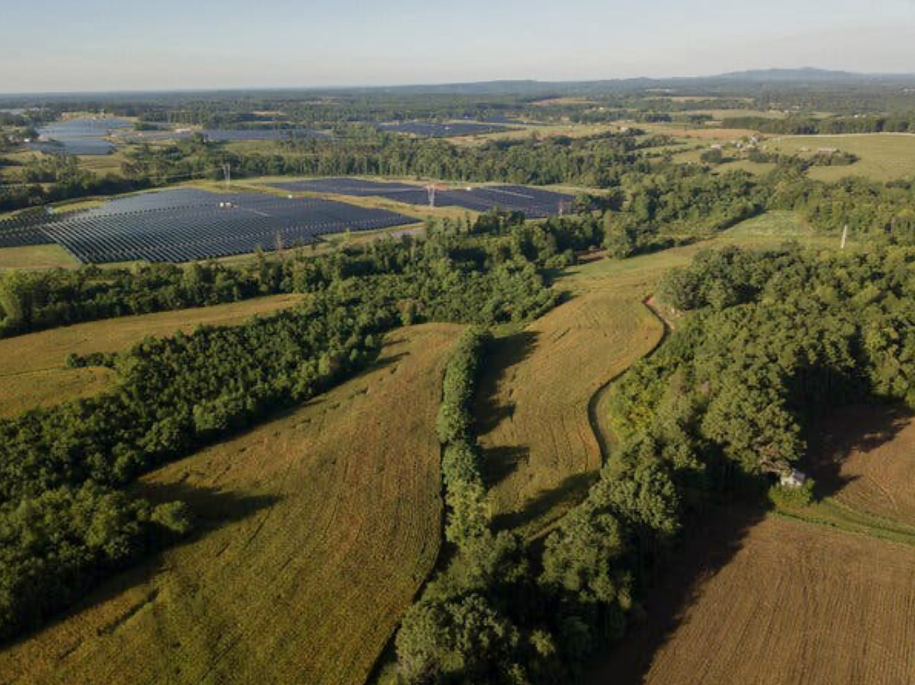 Aerial view of a solar panel array sited within the footprint of a former coal mine.