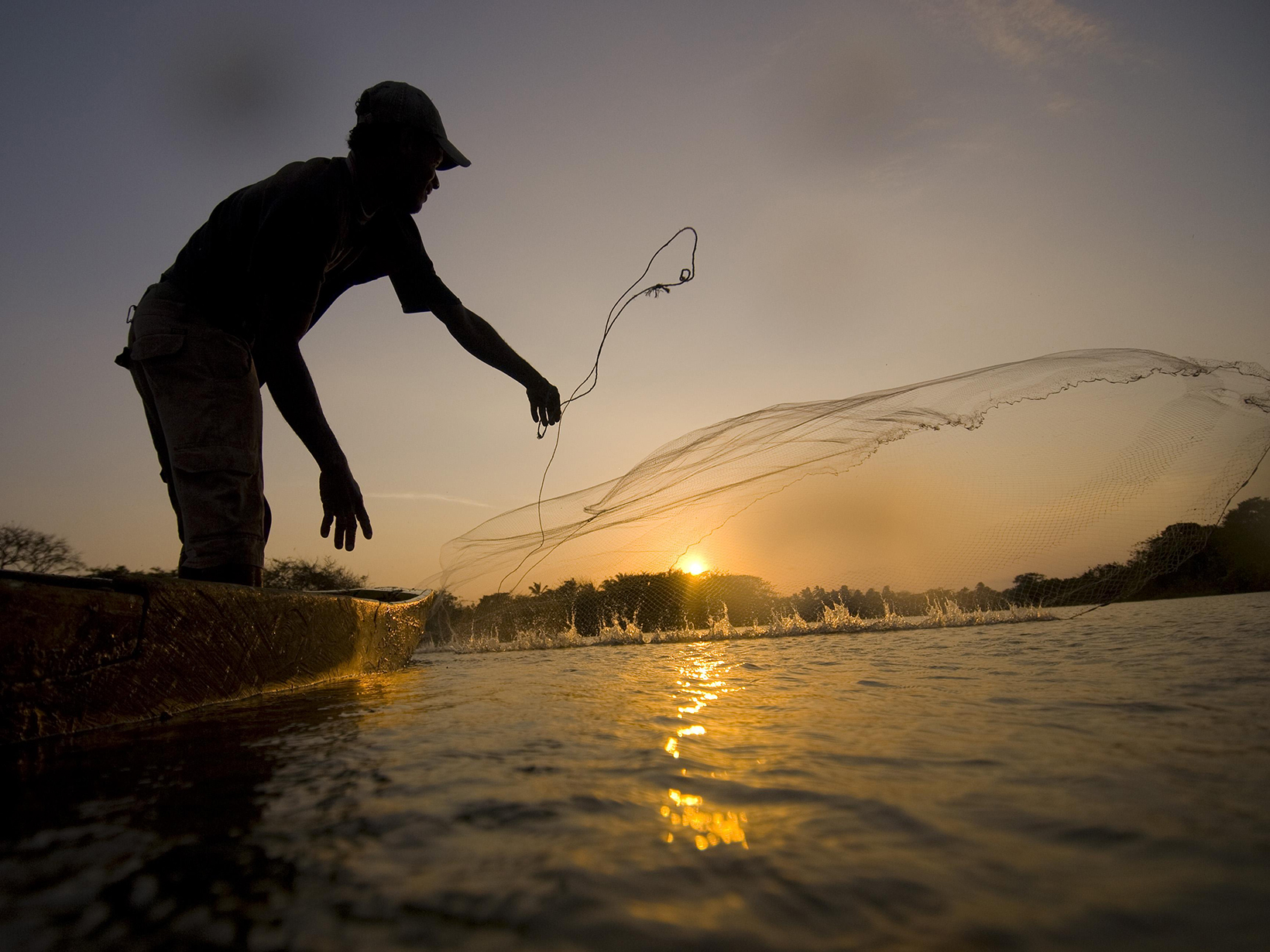 Local fisherman casting a net for fish in Colombia’s lower Magdalena River basin.