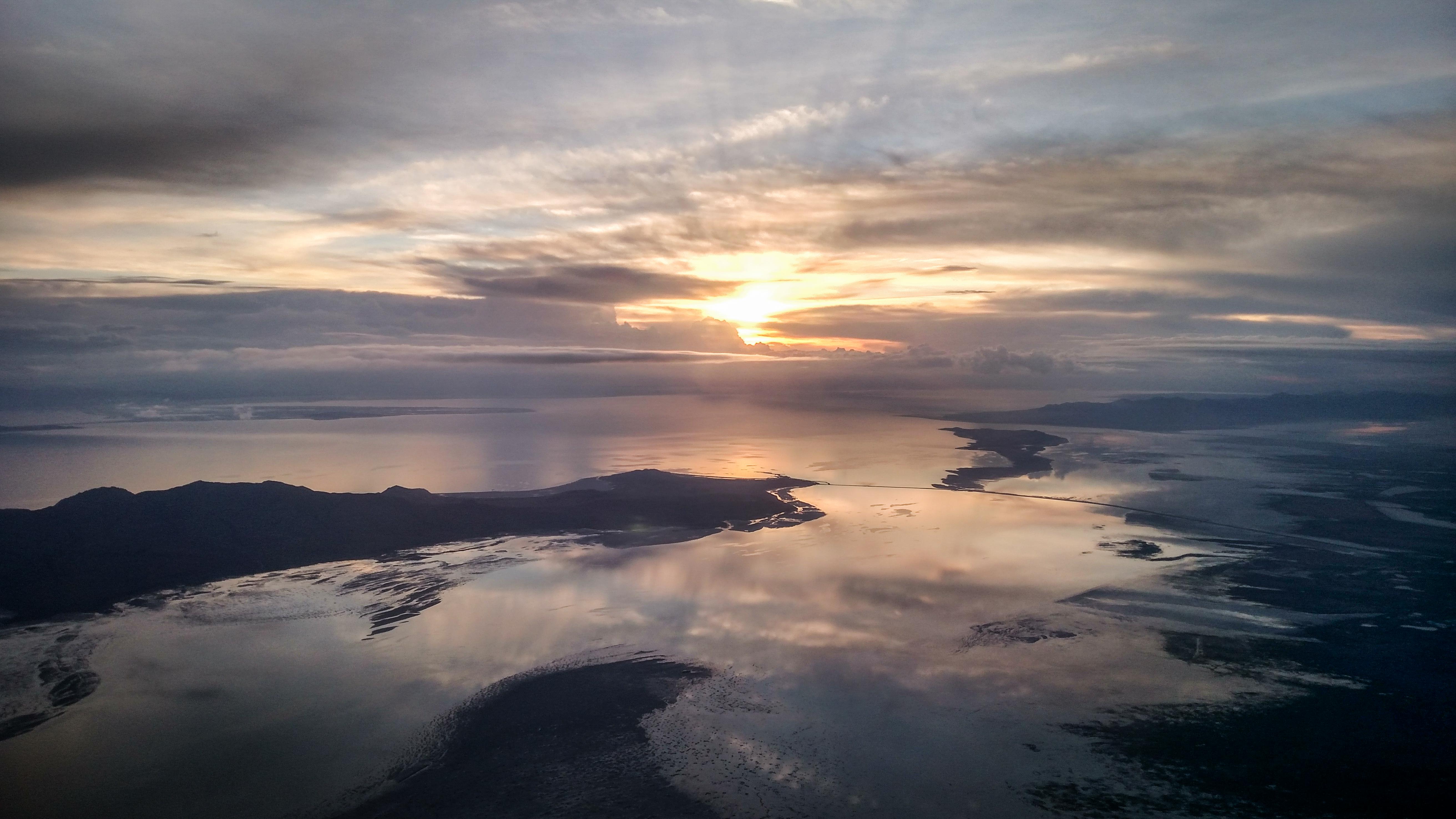 Dramatic aerial view of the sun setting over a the Great Salt Lake.
